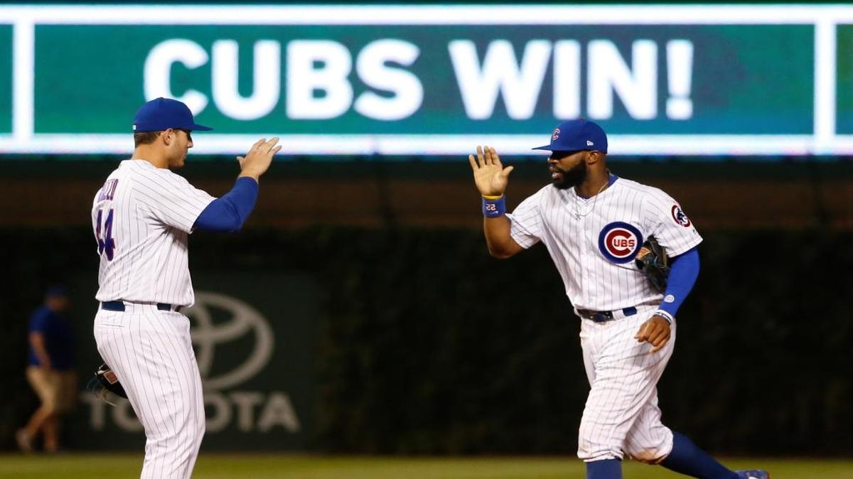 Chicago’s Anthony Rizzo and Jason Heyward celebrate beating the Pirates on Aug. 29. During the game, a foul ball hit a fan who says he was blinded and is now suing the team.