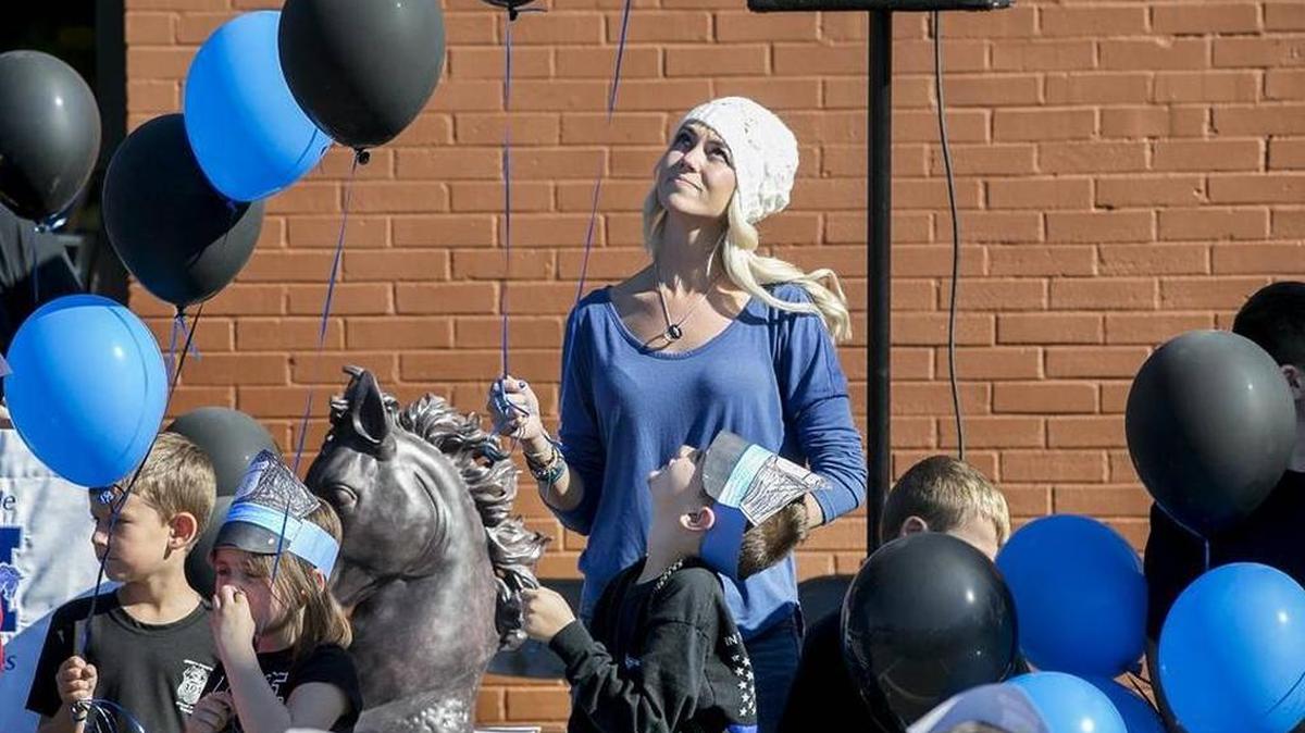 Elizabeth Snyder, the widow of officer Blake Snyder, and her nephew Samuel Skirball prepare to release balloons. Skirball’s school, Maryville Elementary school in Granite City, honored Blake Snyder during a celebration and memorial on Nov. 4.