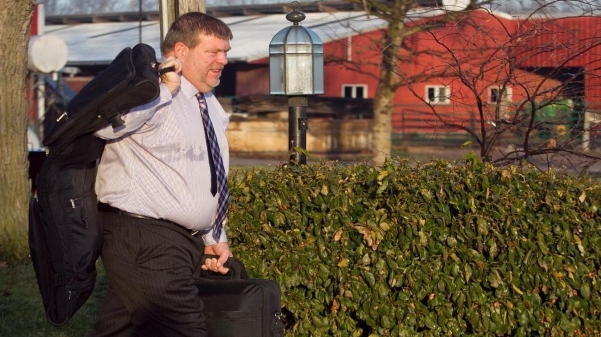 State Rep. Charlie Meier carries his briefcase and garment bag to his vehicle before making a trip to Springfield. Meier is a farmer. Though he’s not a hog farmer, he says bacon has gotten a bad rap from the World Health Organization. He’s sponsoring a House resolution to recognize the pork industry’s contribution to Illinois’ economy