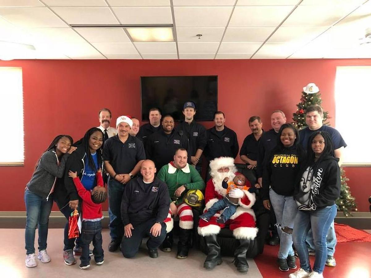 Fairview Heights Fire Department members with the Williams family.