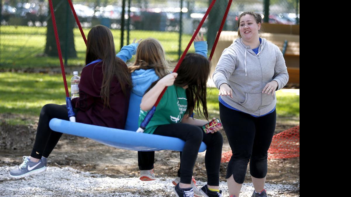 
Randi Williams of Wentzville, MO pushes some friends on a new swing in Hannah's Playground at Northside Park Sunday in Breese.

