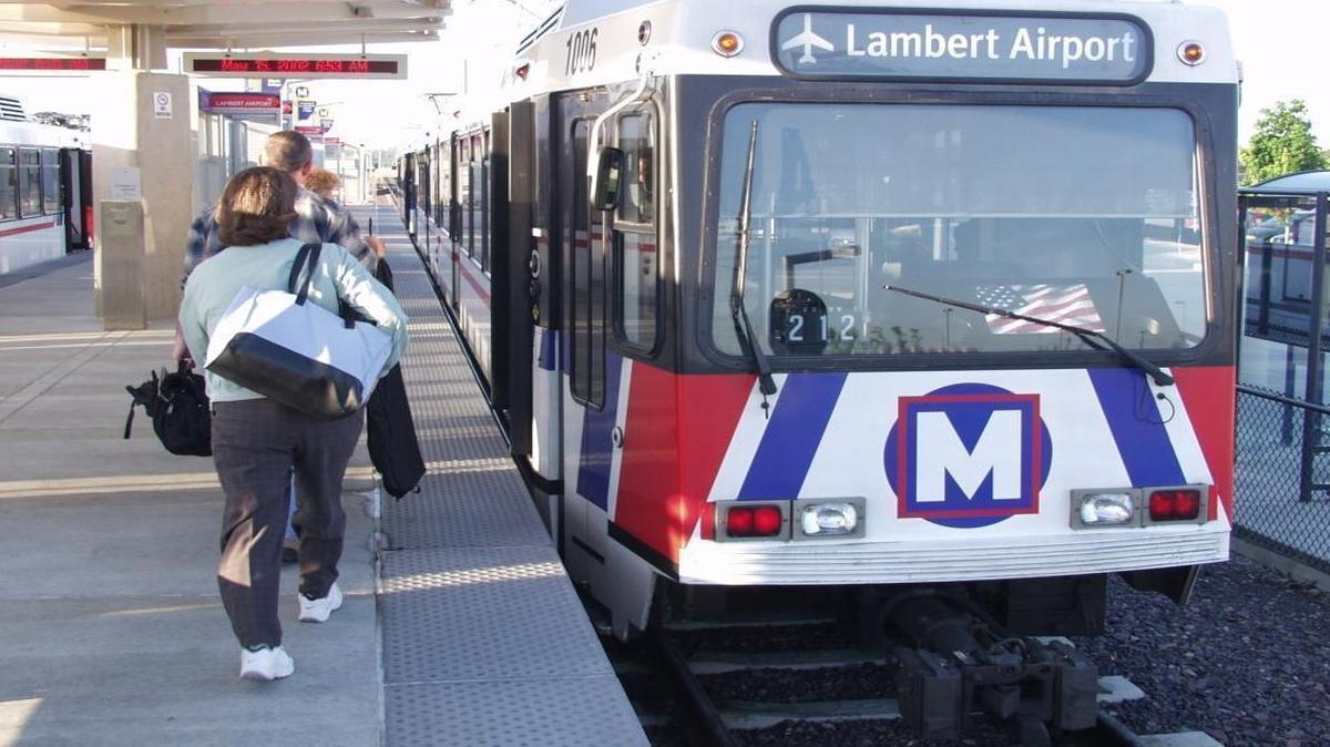 MetroLink passengers board a train bound for Lambert Airport.