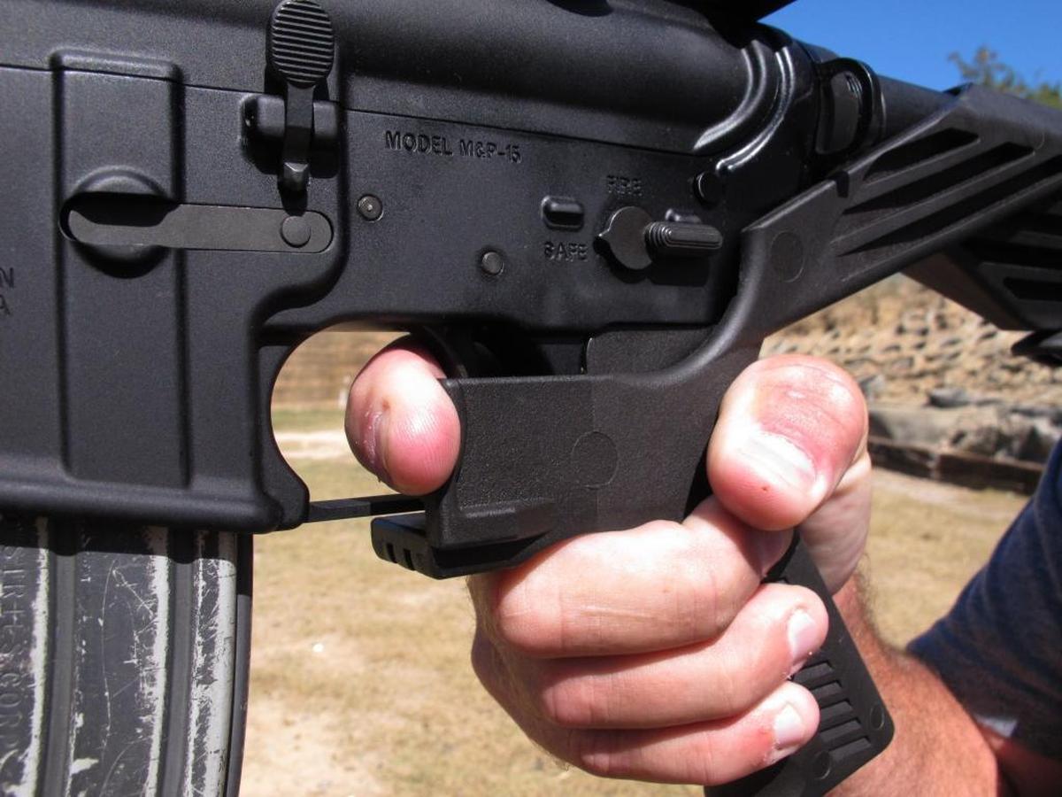 In this Oct. 4, 2017, file photo, shooting instructor Frankie McRae demonstrates the grip on an AR-15 rifle fitted with a “bump stock” at his 37 PSR Gun Club in Bunnlevel, N.C.