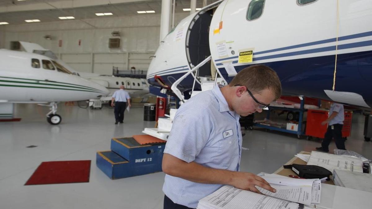 In this BND file photo, Jet Aviation technician Cory Guetterman, of Highland, works on a plane, Thursday, July 12, 2012.