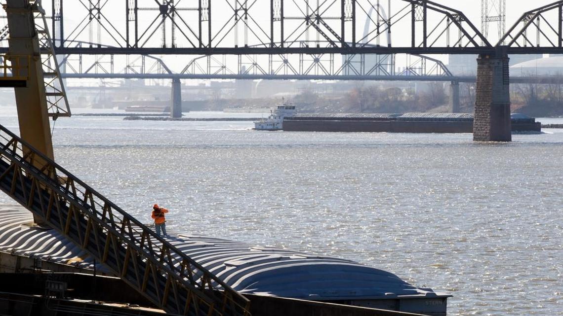 Grain is loaded onto a barge at America’s Central port as a barge passes in the background. By the summer, America’s Central Port is hoping to be loading 20-foot containers on river barges with grain and soy beans so it could be shipped internationally.