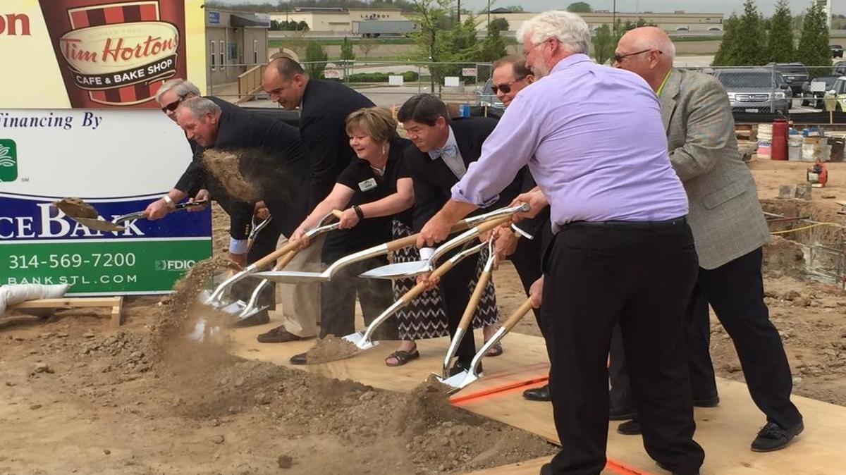 O’Fallon city and business officials break ground Tuesday morning at the site of what will be the Tim Hortons/Reliance Bank building.