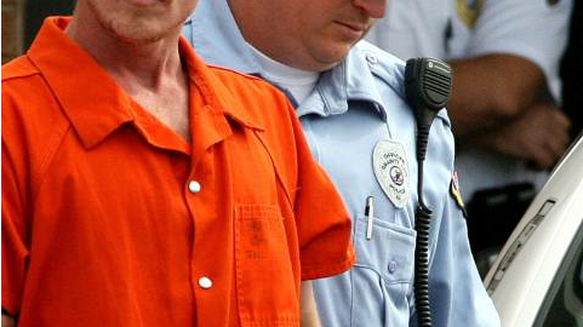 Nicholas Sheley is led out by police following his arrest in Granite City in 2008.