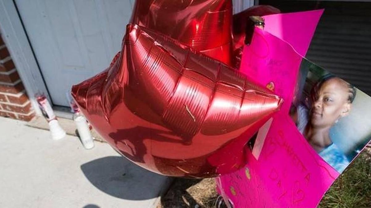 Candles, balloons and pictures crowded the front door to the apartment at 270 Marcella Drive where Sharetta Day lived with her son.