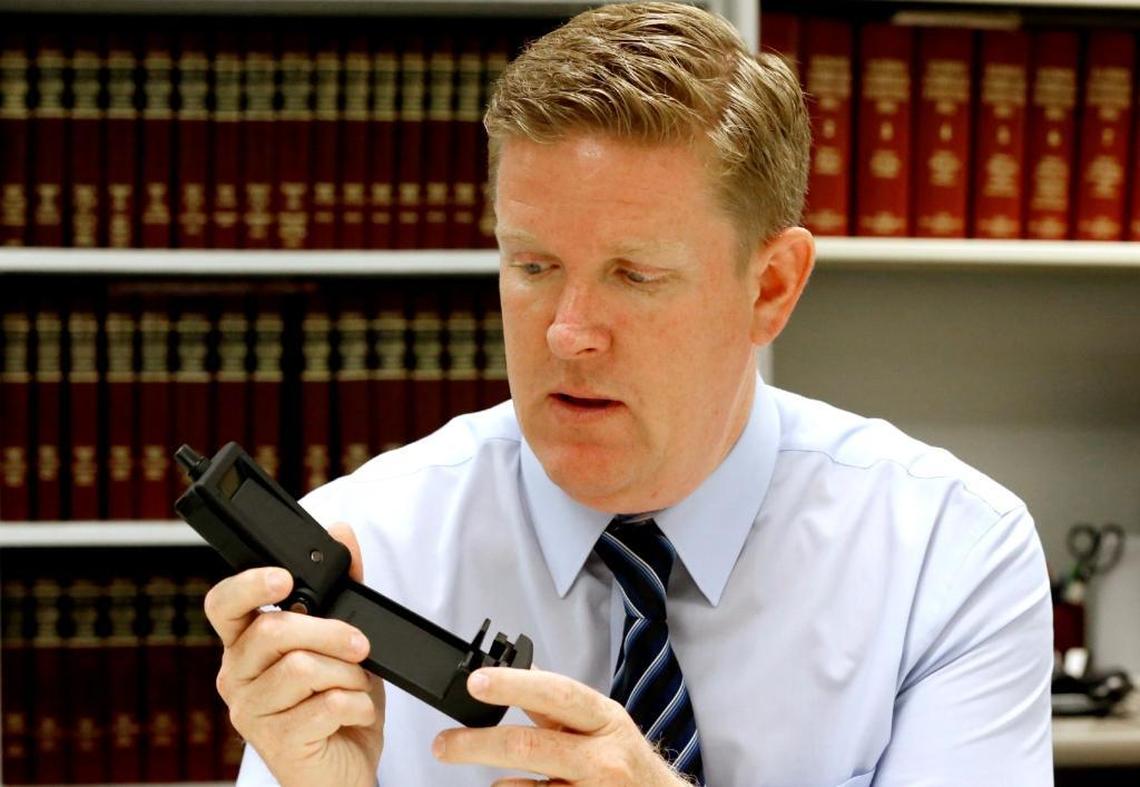St. Clair County State's Attorney holds the TRAC alcohol-testing device used to track whether offenders drink alcohol.