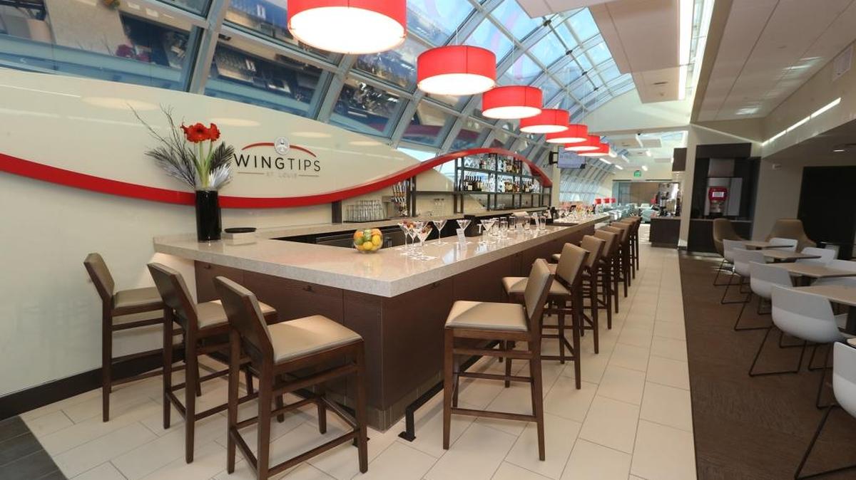 Wingtips St. Louis is a new lounge in Terminal 2 at St. Louis Lambert International Airport that is open to passengers who buy memberships or single-use passes. Seating is available at the bar or tables or along a wall of windows.