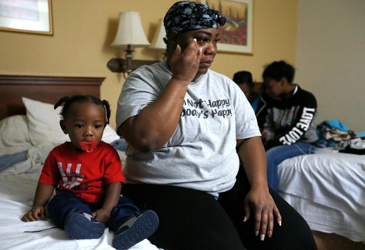 Darneshia Williams talks about having to leave her Fairview Heights home and stay in a hotel with four of her five children while they seek permanent housing. She is shown with them including her son Kendrick Foster, at left) Monday at Americas Best Value Inn.