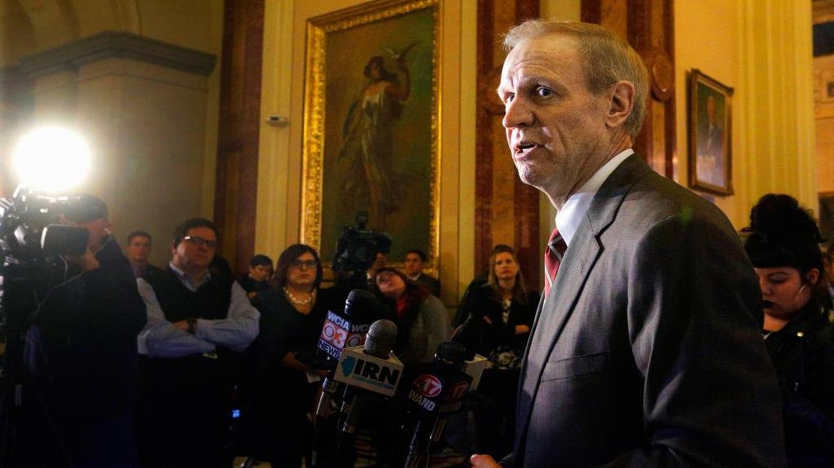 In this Dec. 2, 2015 file photo, Illinois Gov. Bruce Rauner speaks to reporters outside his office at the Capitol in Springfield. Half a year into its deepening budget crisis, the state of Illinois is sitting on at least $4 billion in cash. An Associated Press analysis of state records finds the money in 531 separate accounts set up for special, and specific, purposes, but precedent shows that lawmakers and governors in less anxious times have dipped into those accounts to pay regular state expenses and stave off financial distress.