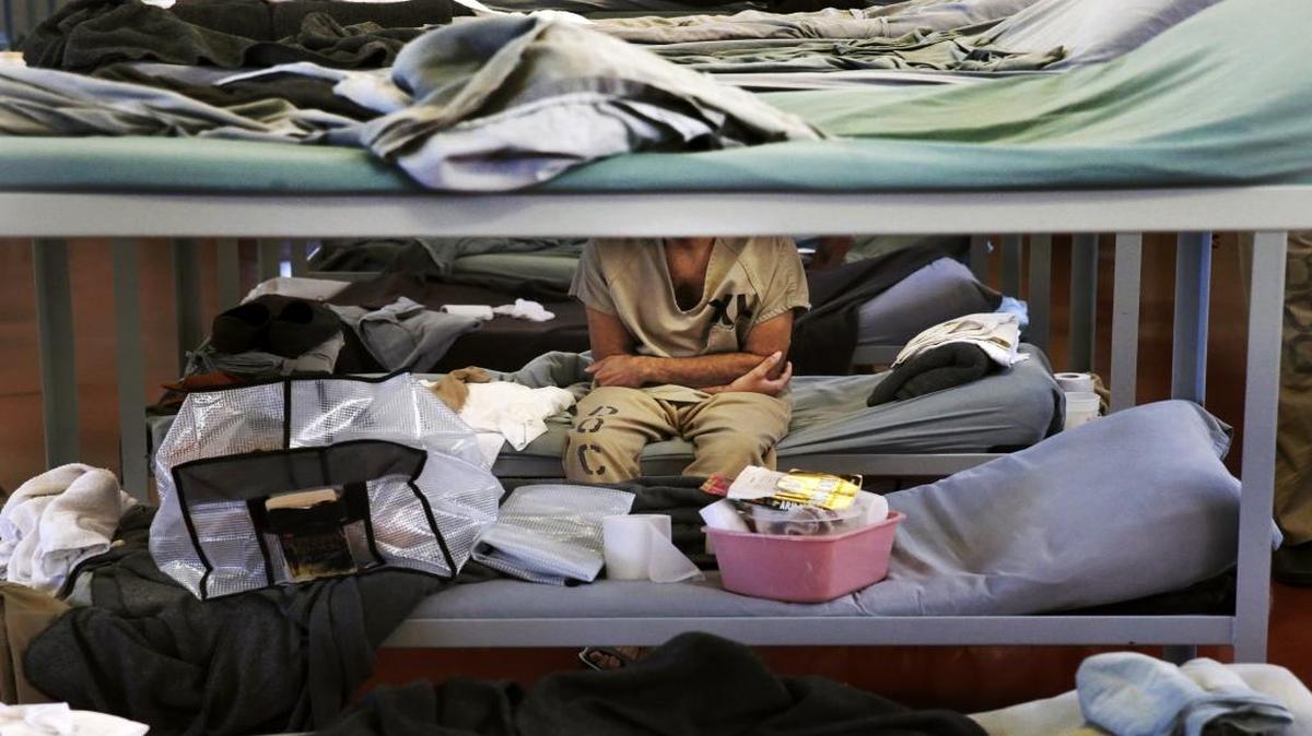 In this June 26, 2014 file photo, a lone inmate in Division 2 Dorm 2 of the Cook County Jail sits arms folded on his bunk in Chicago. Gov. Bruce Rauner wants to reduce the number of inmates in Illinois’ overcrowded prison system over the next decade. It’s an issue that presents the first-term Republican governor with a rare opportunity to find agreement with legislators during a bitter budget stalemate.