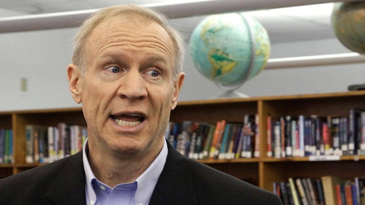 In this Wednesday, May 11, 2016 photo, Gov. Bruce Rauner visits with students at New Berlin High School in New Berlin. Rauner’s vision of a grand, two-year budget compromise with Illinois lawmakers is becoming more difficult to accomplish as the clock ticks down on this year’s legislative session.