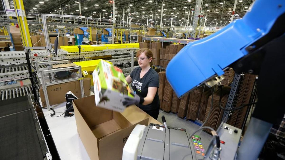 
A worker places an item in a box for shipment at an Amazon.com fulfillment center in DuPont, Wash., on Feb. 13. An Illinois corporate tax credit program suspended earlier this summer amid a state budget crisis has since been offered to Amazon because of a previous commitment to the online retailer. Amazon announced its plans in August for a Joliet warehouse that will create 1,000 full-time jobs when it opens. The 500,000-square-foot fulfillment center is its first in Illinois.
