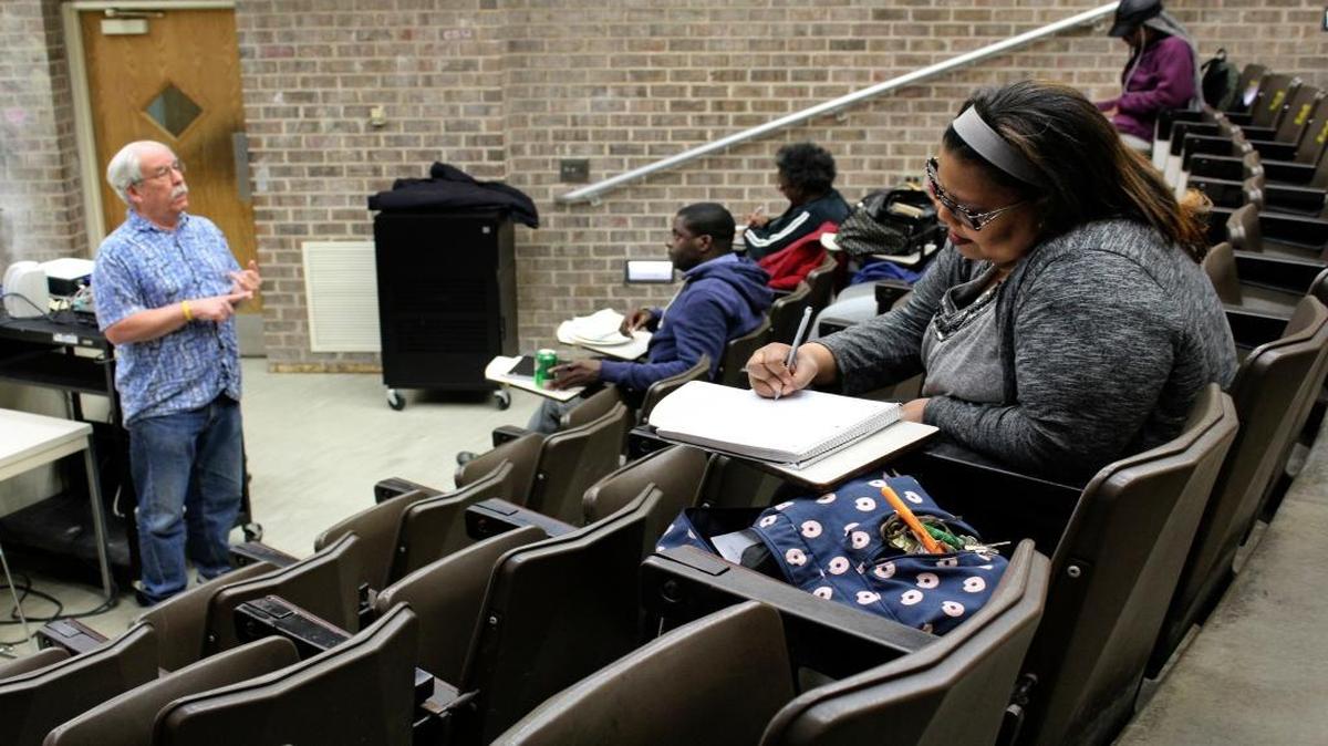 In this April 12, 2016 photo, Robert Bionaz, an associate professor of history at Chicago State University, lectures during a class at the university in Chicago. The school has a troubled history and has been hard hit by the state budget crisis, but students and experts say it remains a last shot for many to get a degree.