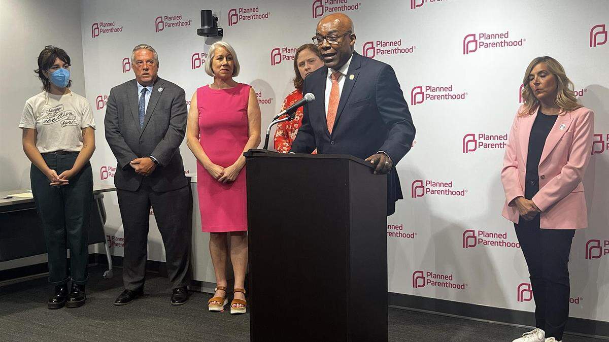 Illinois Attorney General Kwame Raoul stands with fellow abortion rights advocates on Thursday to celebrate the signing of a bill allowing Illinoisans to sue crisis pregnancy centers that engage in “deceptive acts” aimed at deterring abortions.