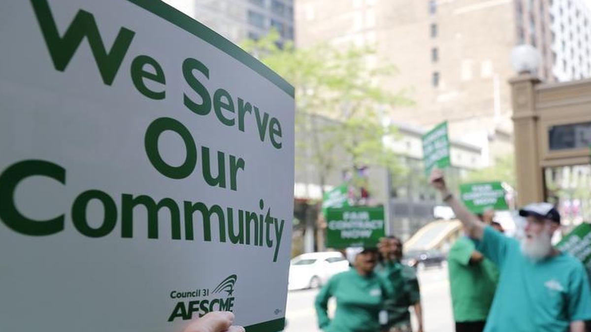 In this June 9, 2015 photo, members of the American Federation of State, County and Municipal Employees protest in Chicago. They will rally in Springfield today to push for more legislative clout and their $3 billion contract demands.