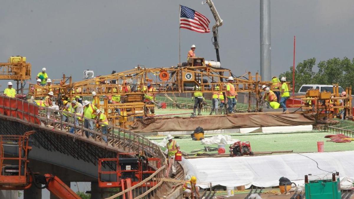 A large crew of workers helped build the Interstate 64, 55 and 70 interchange and approaches in East St. Louis for the new Mississippi River Bridge in 2013. The Illinois Policy Institute has released a study that says repealing the Prevailing Wage Act could help stimulate the construction sector while saving money on public projects.
