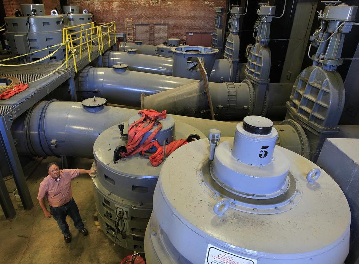 Metro East Sanitary District Director Steve Adler is dwarfed by the massive pump motors inside the pumping station where the Cahokia Canal enters the Mississippi River.