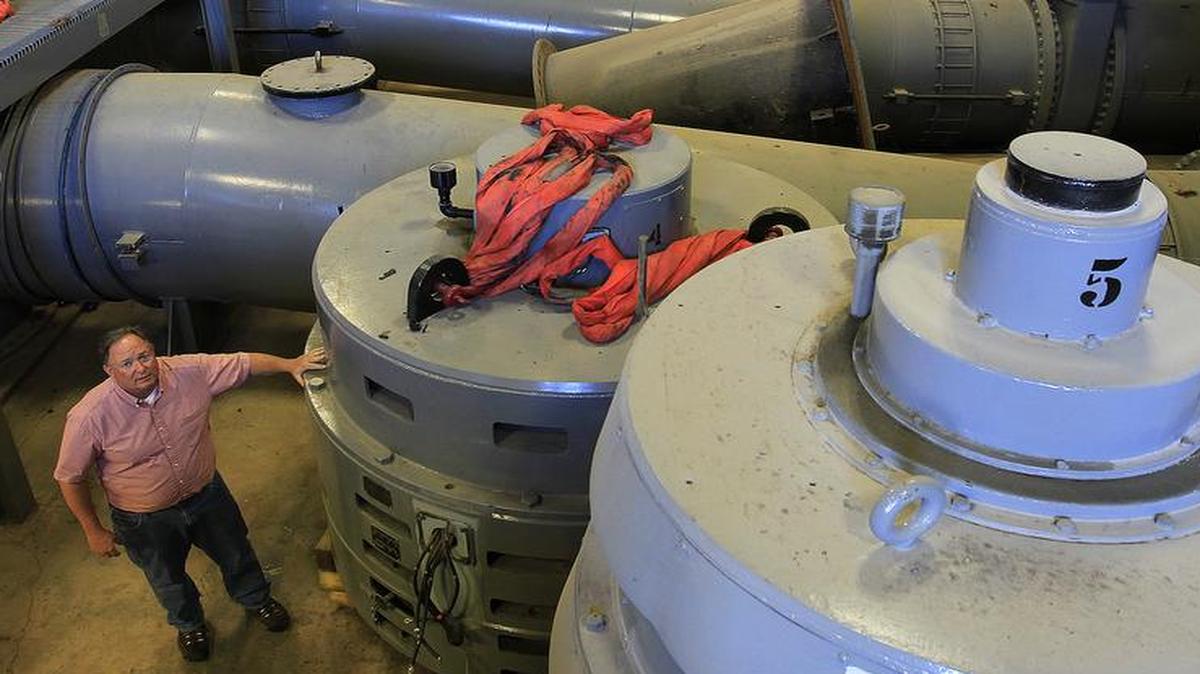 Metro East Sanitary District Director Steve Adler is dwarfed by the massive pump motors inside the pumping station where the Cahokia Canal enters the Mississippi River.