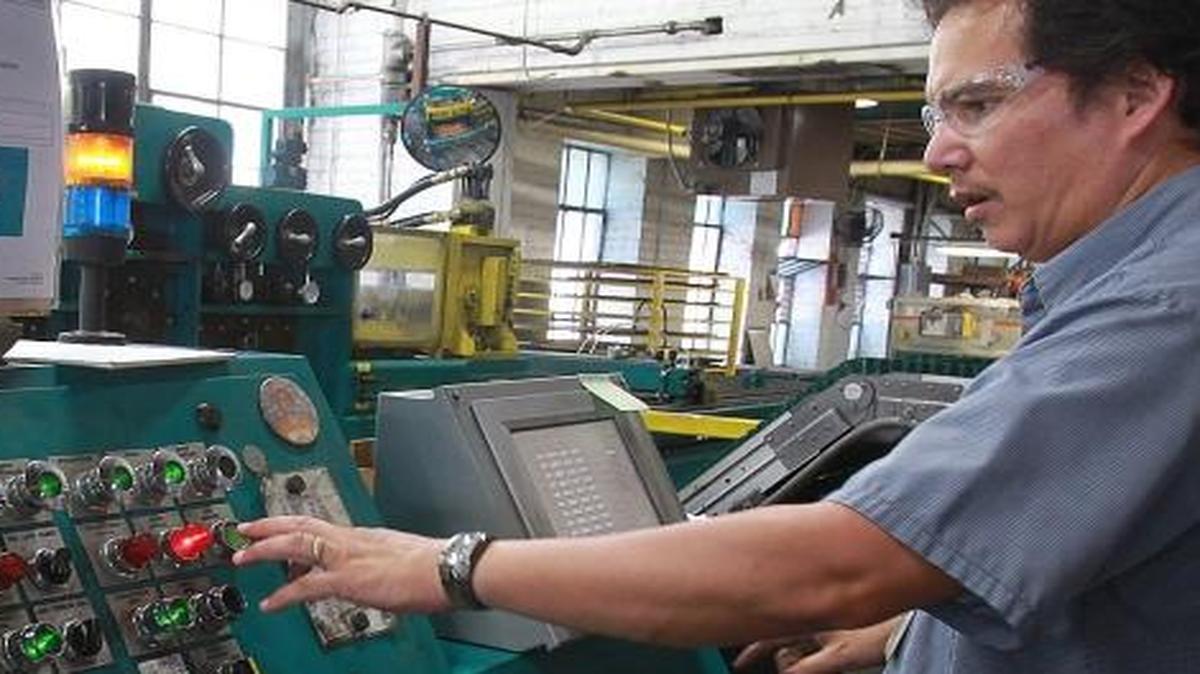 Paul Hefner in 2012 cuts sheet metal to length for manufacturing gas stoves at Empire Comfort Systems in Belleville. Illinois has lost 8,000 manufacturing jobs so far this year, more than each of the total year losses since the Great Recession.