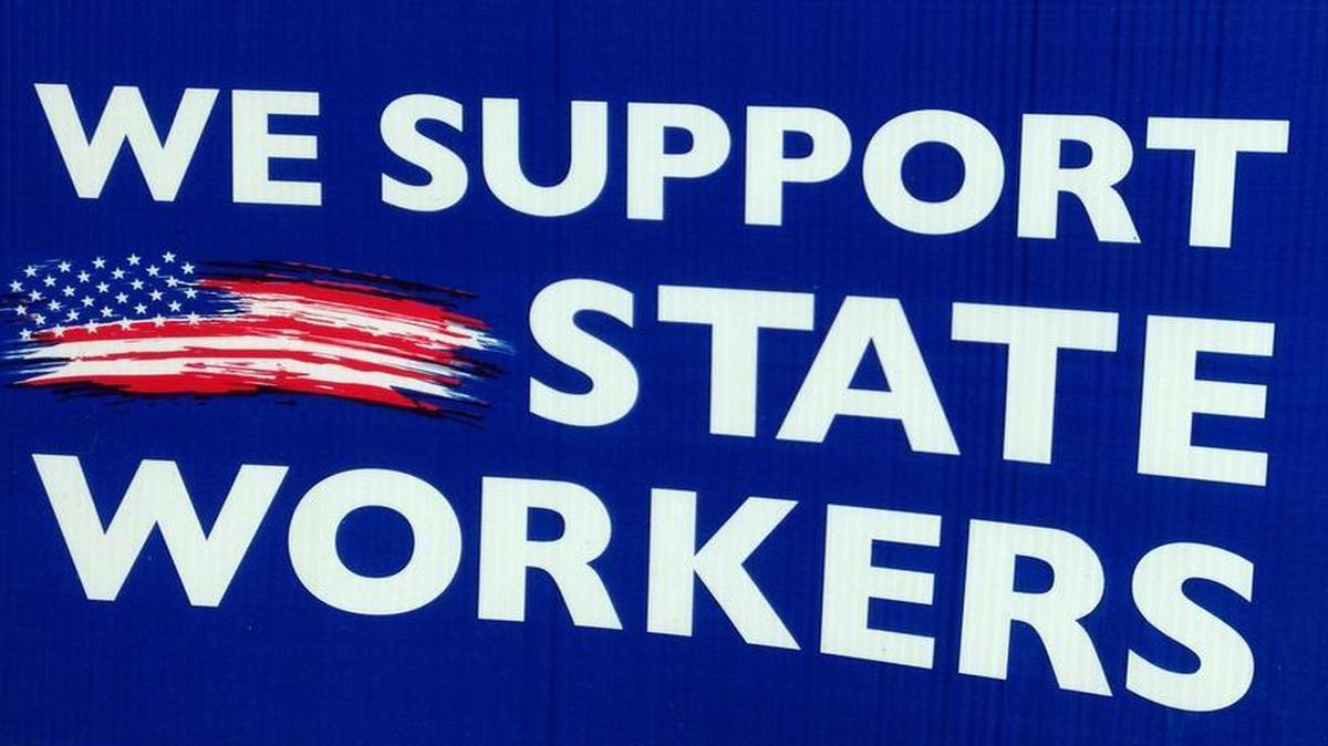 A yard sign in Belleville shows support for state workers, and how.