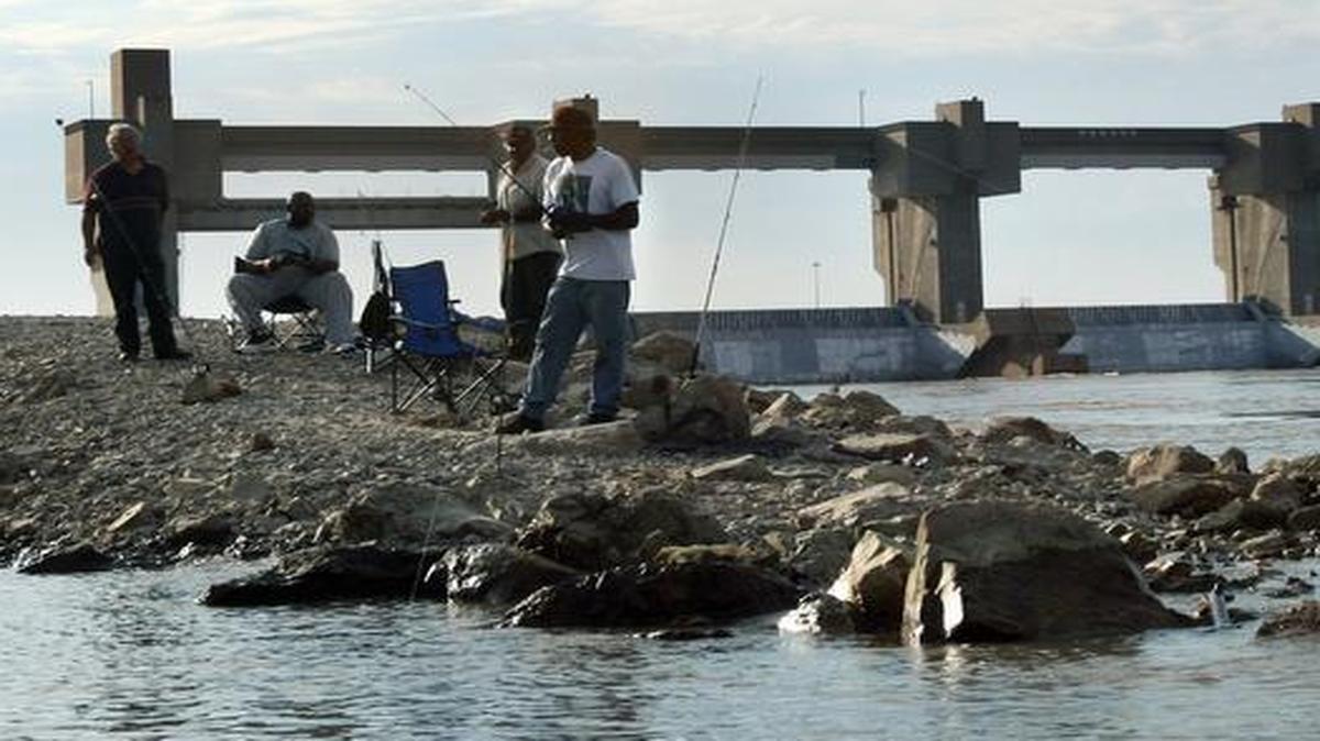 
People fish near the Alton Lock and Dam. River infrastructure is not being maintained, leading a study to give maintenance efforts an F grade.
