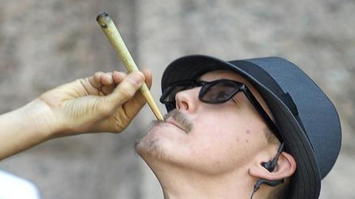 Illinois is looking at decriminalizing marijuana, but how long until it is legalized? Shaun McAlister, executive director of the Dallas/Fort Worth chapter of NORML, invites the crowd to light up on May 7 during a legalization rally in Texas.