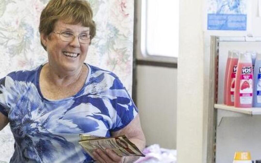 JoAnn Nadler smiles at a client as she helps select their food. Nadler and other volunteers at the Fairview Heights Area Food Pantry are likely moving into the basement of City Hall.