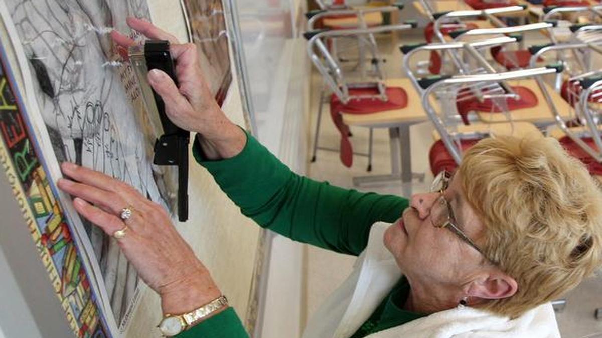Eighth grade language arts teacher Judy Herzog in 2011 put up decorations in her new classroom at Belle Valley School in Belleville. The district got state lawmakers to expand their borrowing limit so they could take on $40 million in debt over 30 years to build the school.