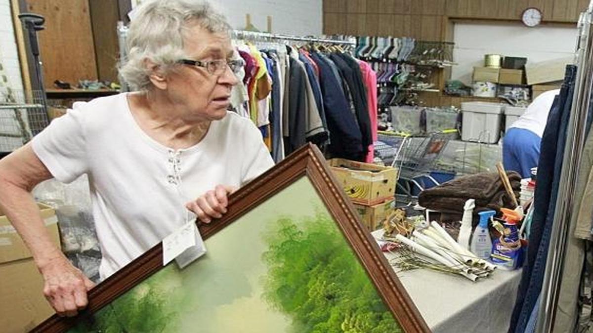 Belleville decided to limit second-hand stores to 10, with only two allowed in the downtown area. Here volunteers at the Community Kindness Resale Shoppe handle donations.