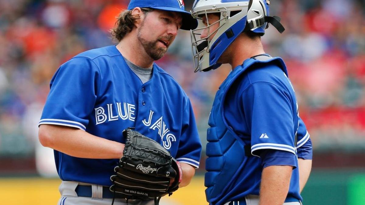 Toronto Blue Jays starting pitcher R.A. Dickey, left, and catcher Josh Thole, right, meet on the mound for a conference in-between pitches during the third inning of a baseball game, Saturday, June 15, 2013, in Arlington, Texas.