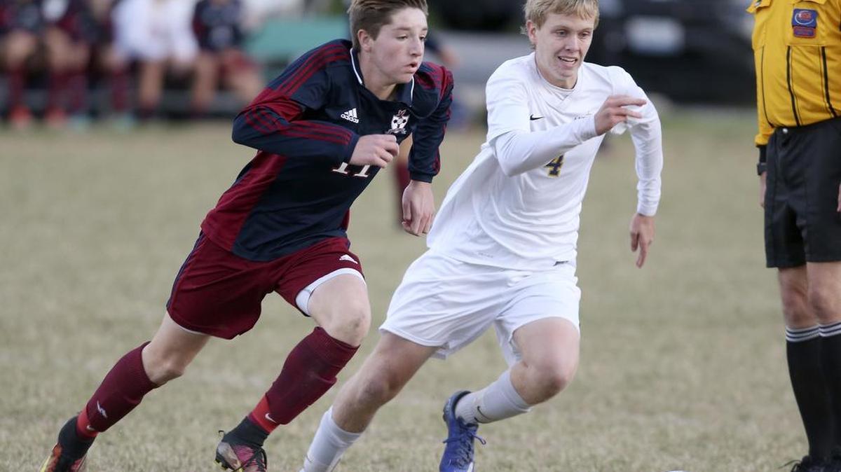Gibault’s Karson Huels and Althoff’s Mitchell Kidd sprint to the ball during the Class 1A soccer sectional championship in 2017.