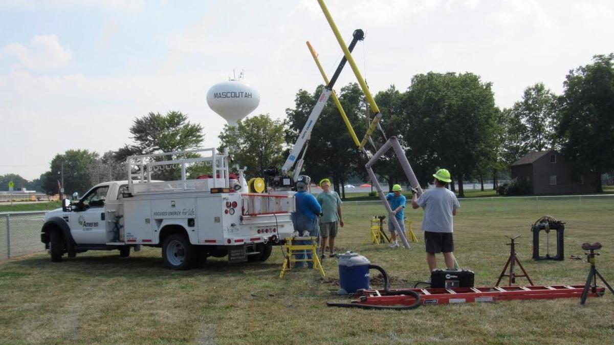 
Mascoutah Little Indians volunteers work with Ameren equipment to help raise new goalposts
