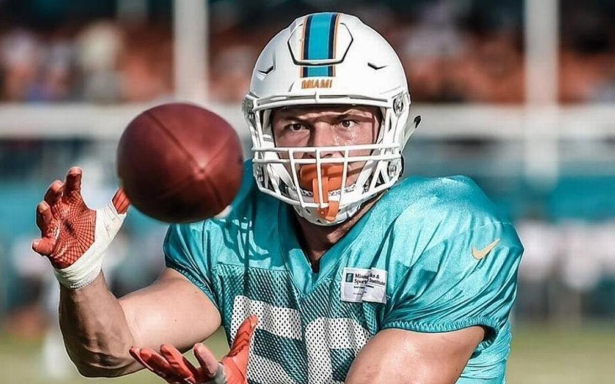 Belleville East graduate Chase Allen, shown here with a coach during Miami Dolphins’ training camp, said he learned he made the NFL team’s 53-man roster by the phone call he didn’t get last Saturday.