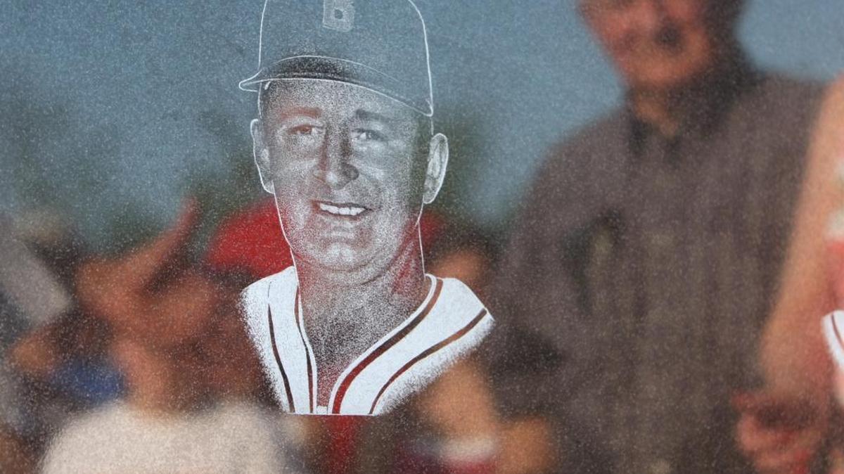 Barney Elser is reflected in a plaque honoring him and fellow Hilgard coach John Schmidt.
