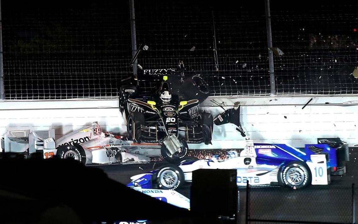 Ed Carpenter lands on top of the car driven by Will Power, of Australia, during a wreck in Turn 2 during the IndyCar Bommarito Automotive Group 500 auto race Saturday, Aug. 26, 2017, at Gateway Motorsports Park in Madison, Ill.