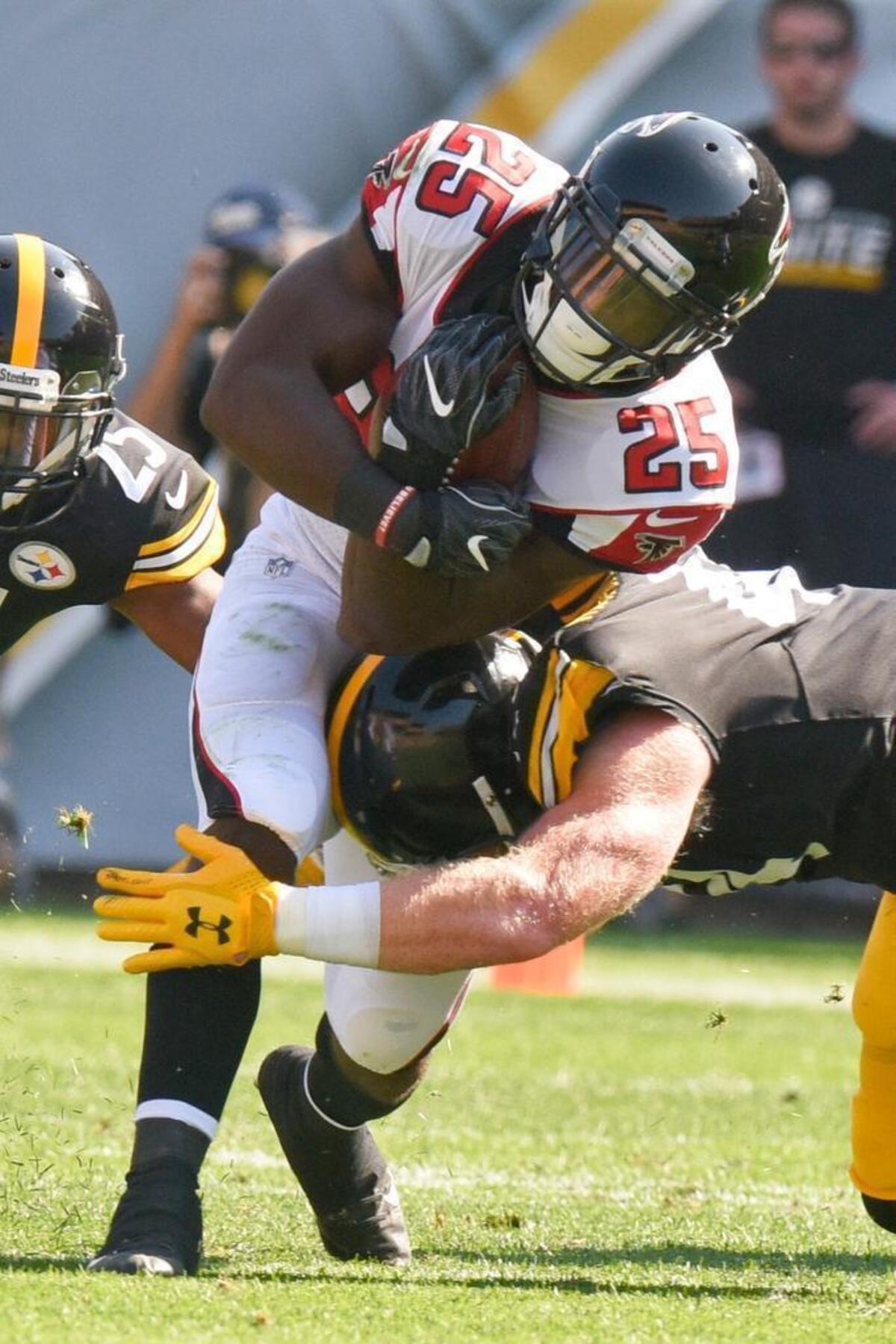 Atlanta Falcons running back Brian Hill (25), a Belleville West graduate, runs the ball as Pittsburgh Steelers outside linebacker Tyler Matakevich (44) defends in the first half of an NFL preseason game Sunday in Pittsburgh.