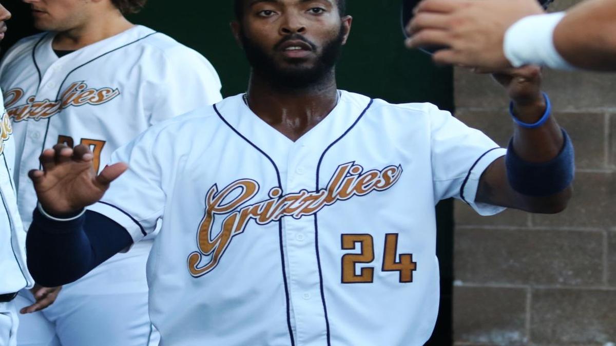 Blake Brown of the Grizzlies is congratulated after scoring in the first inning against Washington.