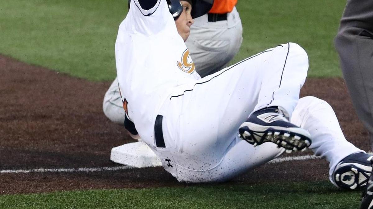 Joliet third baseman Danny Zardon shows the umpire the ball after tagging out the Grizzlies Cody Livesay who was trying to stretch a double to a triple.