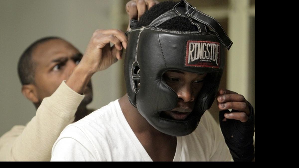 
Arther “Flash” Johnson helps Belleville boxer Keeion Anderson adjust his headgear. Anderson will fight in one of the main events at Johnson’s revived amateur boxing invitational, Saturday at the Jackie Joyner-Kersee Center in East St. Louis, Saturday at 7 p.m. Doors open at 6 p.m.
