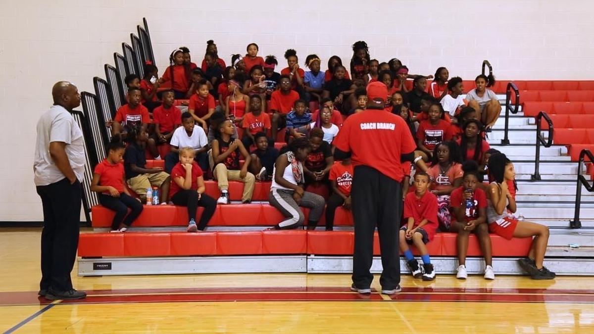 Coach Cortez Branch addresses the Mason/Clark Middle School cross country team before practice Wednesday.