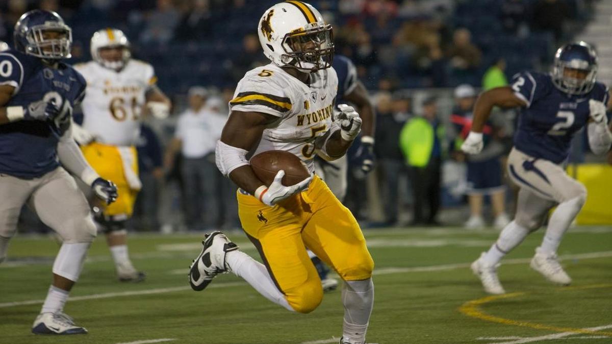 Wyoming running back and Belleville West graduate Brian Hill runs for a touchdown in the second half against Nevada on Saturday. (AP Photo/Tom R. Smedes)