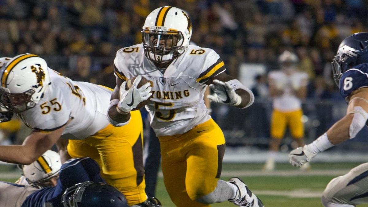Belleville West graduate and former Wyoming running back Brian Hill competes against Nevada during the 2016 season. Hill was invited to the NFL Combine in Indianapolis and ir projected as a potential mid- to late-round draft pick.