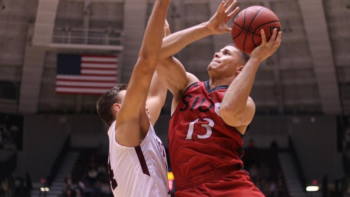 SIUE Cougars guard Christian Ellis goes up for a layup against SIUC’s Rudy Stradnieks during the second half of their game Wednesday night.