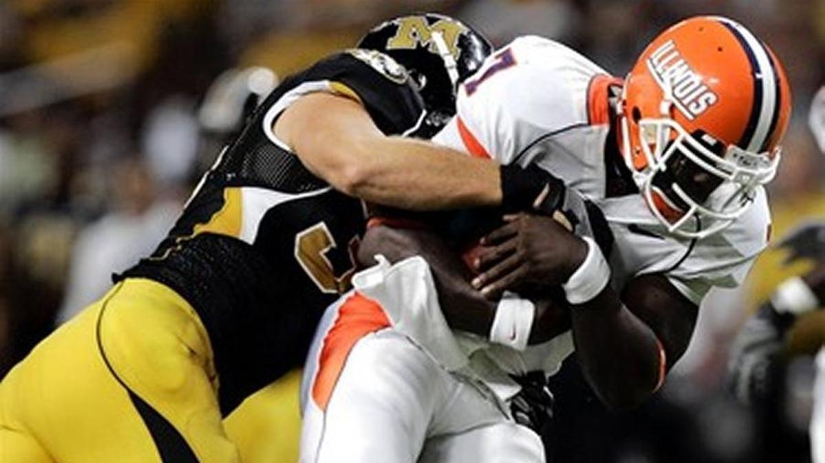 Illinois quarterback Juice Williams, right, is sacked for a 7-yard loss by Missouri lineman Stryker Sulak during the third quarter of a football game Saturday, Aug. 30, 2008, in St. Louis.