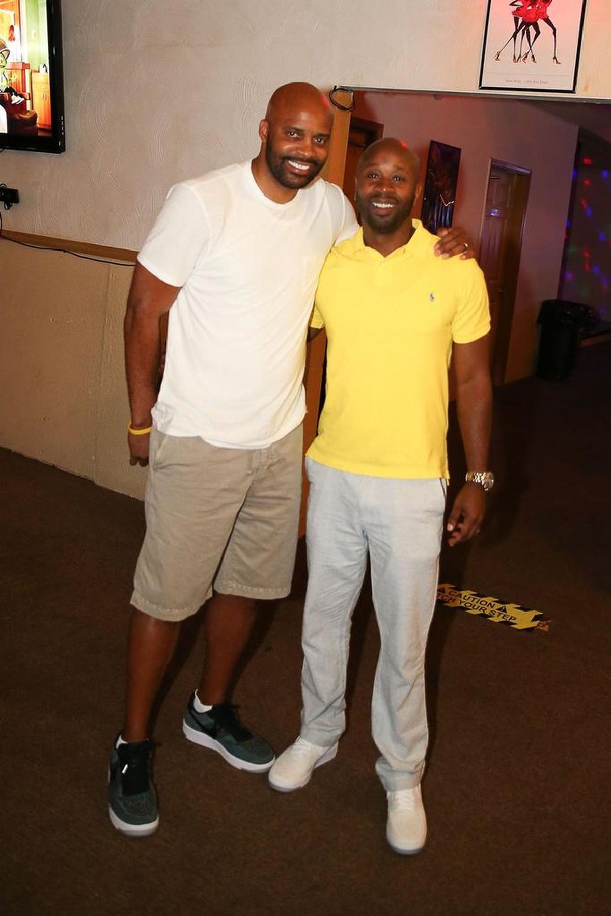 Cuonzo Martin and Marco Harris pose for a photo at a July 2016 fundraiser in East St. Louis, where their charity organization, Bonded Together, raised money to give scholarships to local high school students. Martin, Harris and nine other friends decided to create Bonded Together to give back to East St. Louis, where they grew up.
