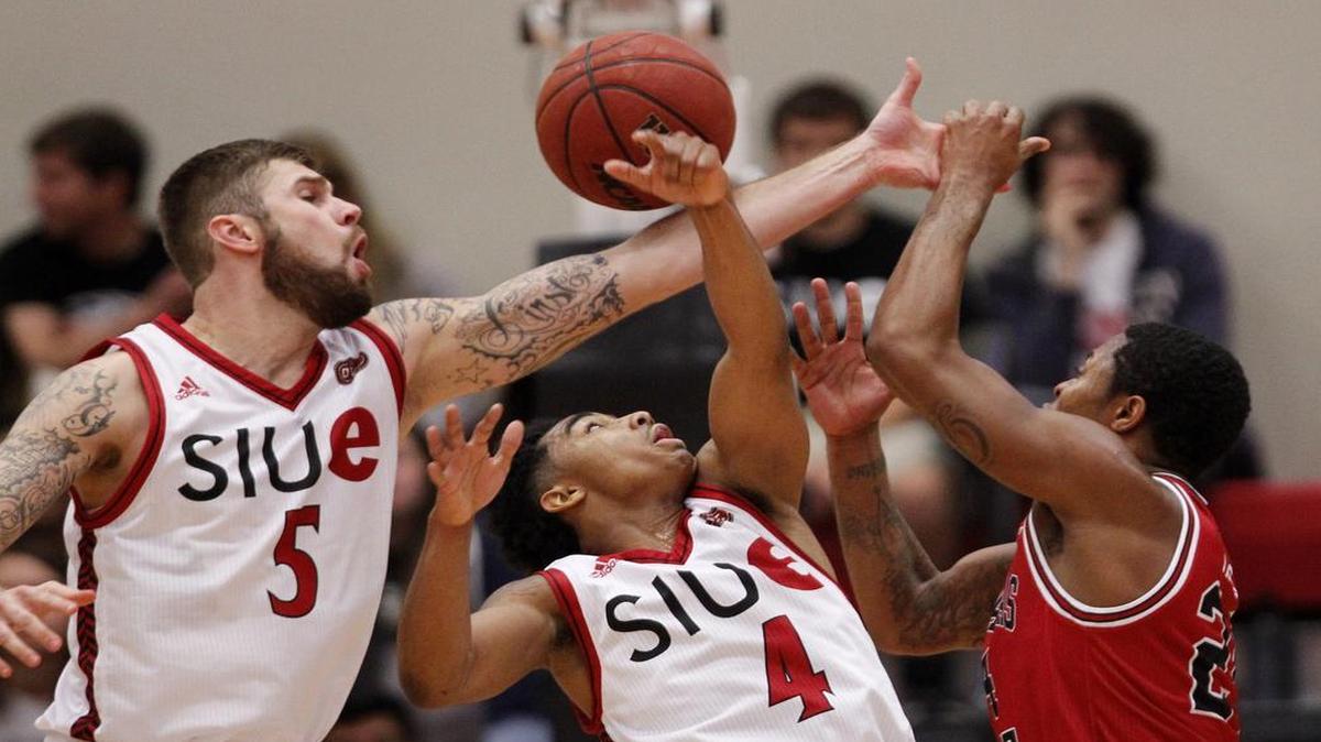 SIU-Edwardsville's (5) Grant Fiorentinos and C.J. Carr battle Arkansas State's Donte Thomas for a rebound during the first half of their game at Southern Illinois University, Edwardsville on Friday.