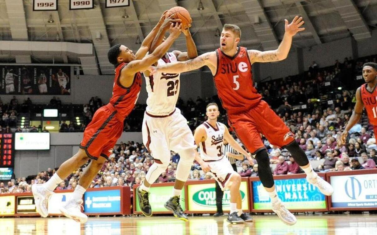 SIU-Edwardsville guard C.J. Carr and center Grant Florentines battle for a rebound with the Salukis center Bola Olaniyan in the second half at SIU Arena on Wednesday evening.